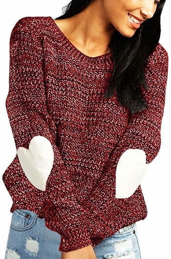a model in the burgundy sweater with white hearts on the elbows