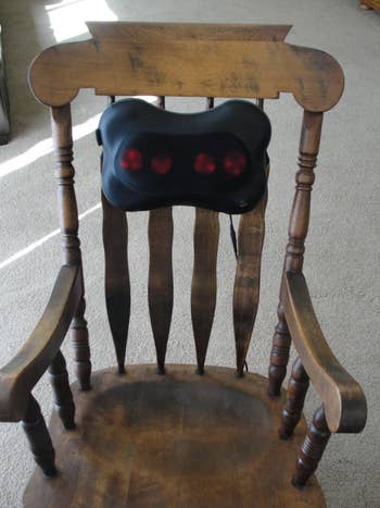 The massager strapped to the back of a chair