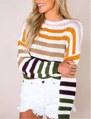 a model in the sweater with different colored stripes