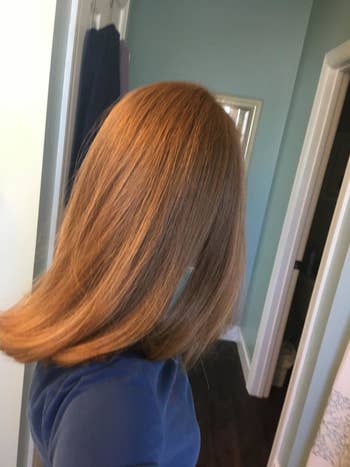 Reviewer showing shiny, straight hair after using the brush