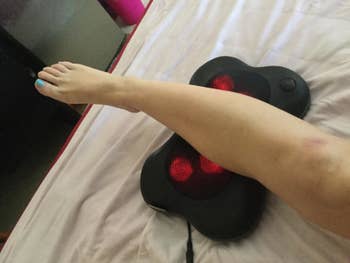 Reviewer using the massager on their calf
