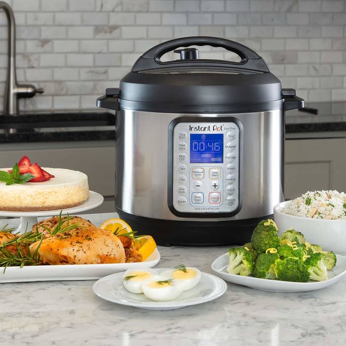 An Instant Pot with plates of food around it