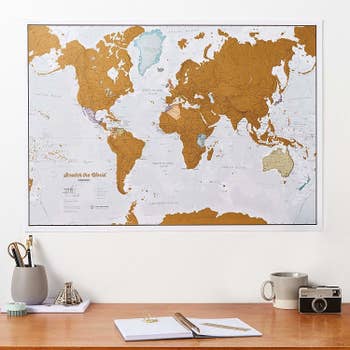 The world map hung on a wall
