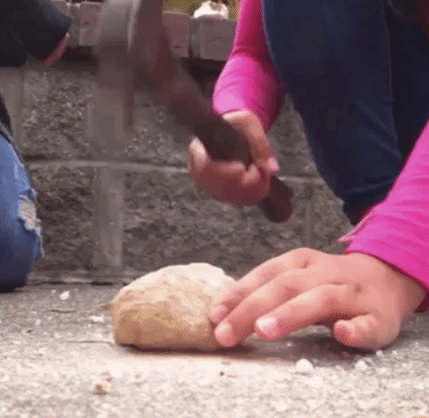 Gif of a child splitting the geode with a hammer