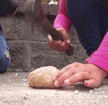 Gif of someone smashing open the geode with a hammer