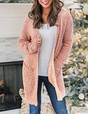 a model wearing the open cardigan in blush pink