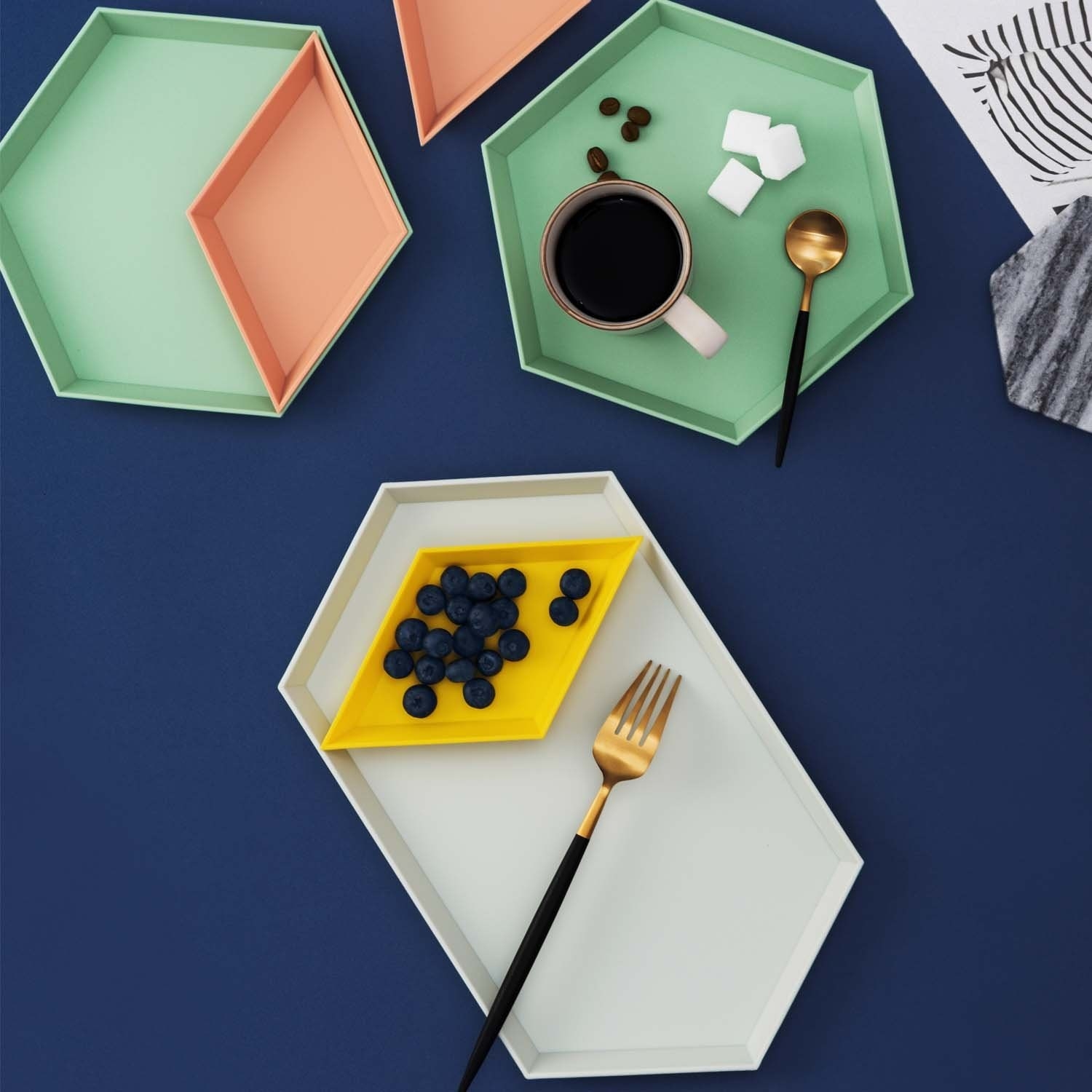 the interchangeable tray with yellow, green, orange, and white pieces 