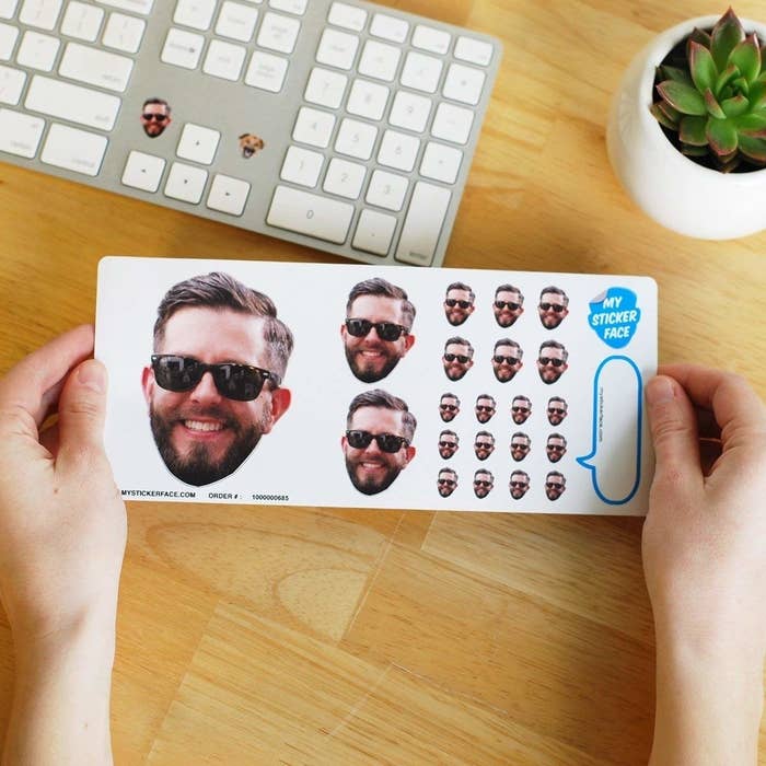 A sheet of stickers in the shape of someone&#x27;s face, in three four sizes: one extra large, two large, six medium, and 12 small