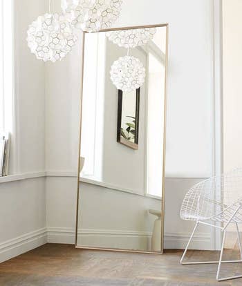 rectangular full-length mirror with a gold frame