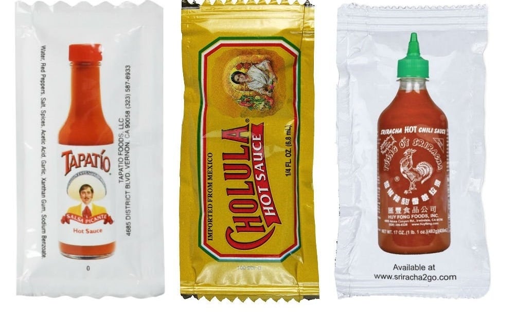 packets of Tapato, Cholula, and Sriracha sauces
