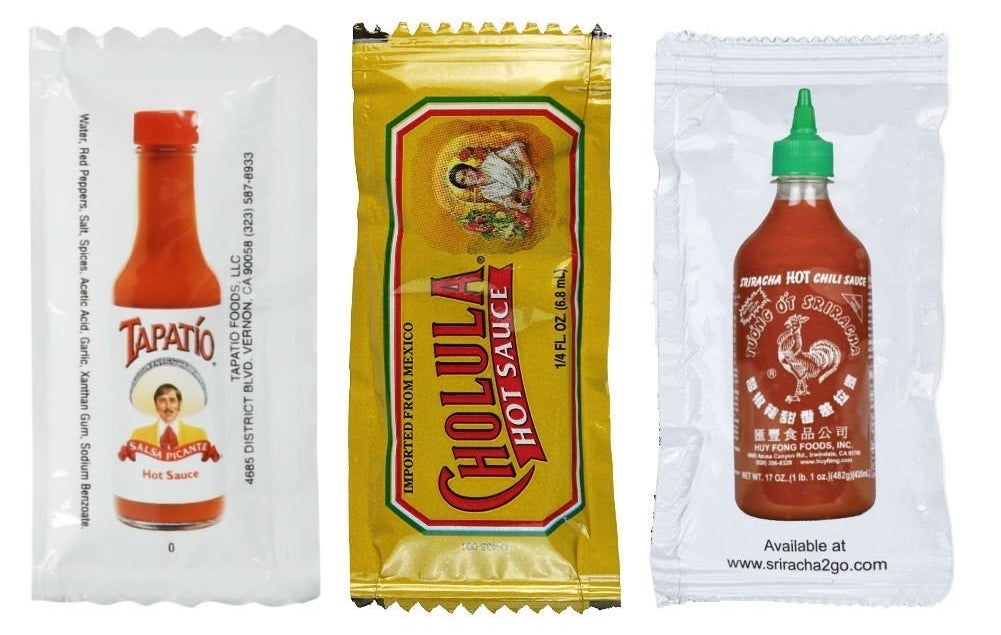 packets of Tapato, Cholula, and Sriracha sauces