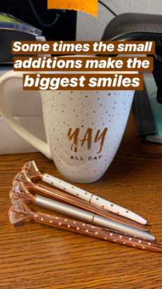 the metallic, polka dot pens with fake diamond on top in front of a coffee mug on a desk