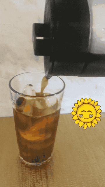 a moving gif of a buzzfeed reviewer pouring cold brew into a glass