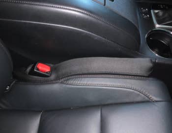 a reviewer's car with the car seat gap filler in it