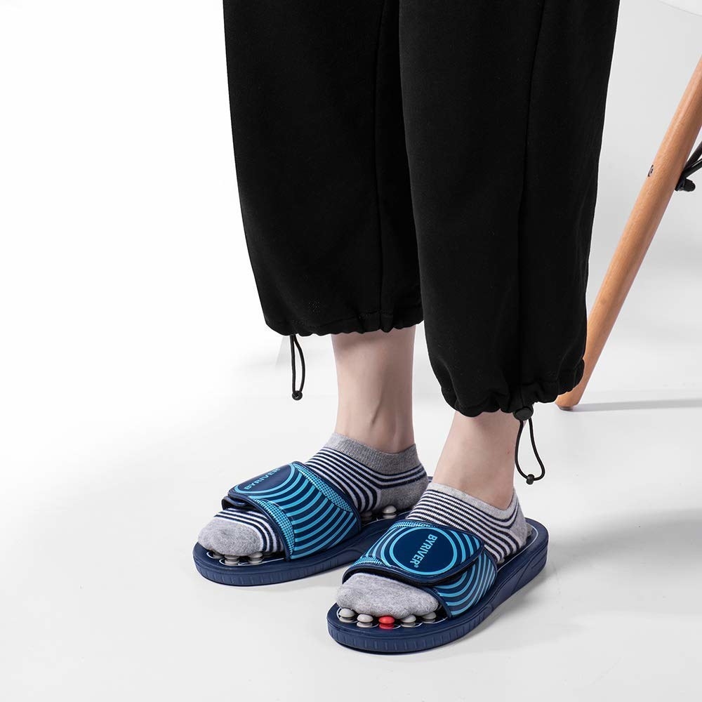 model wears slides with nodes that massage soles of feet