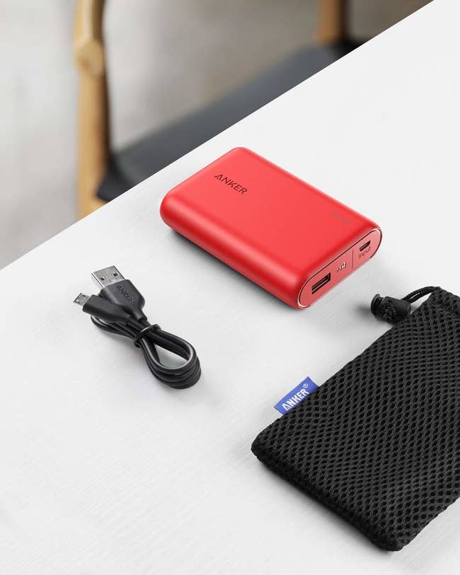 red rectangle with case and USB cord 
