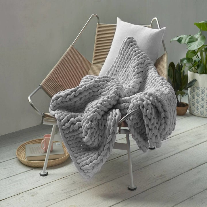 the blanket in gray on a chair