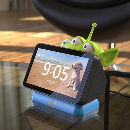 a toy story alien holding an amazon echo show 5