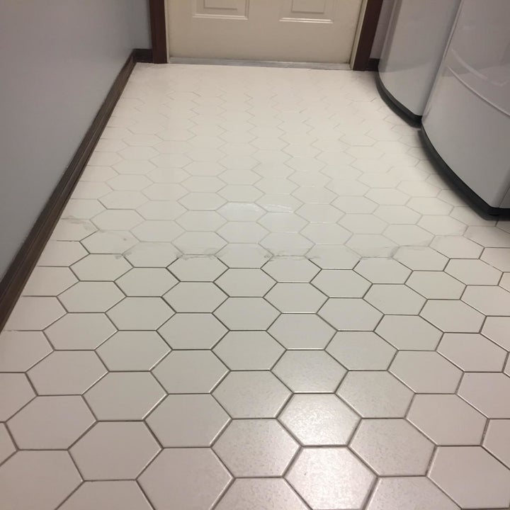 reviewer's tile floor with half of it showing dirt between the tiles and the other part with it looking clean and white between the tiles 