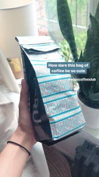 buzzfeed editor holding the teal bag of coffee