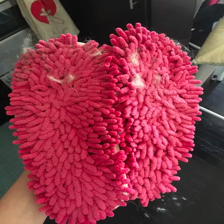 Her slippers with dust and lint on the bottom 