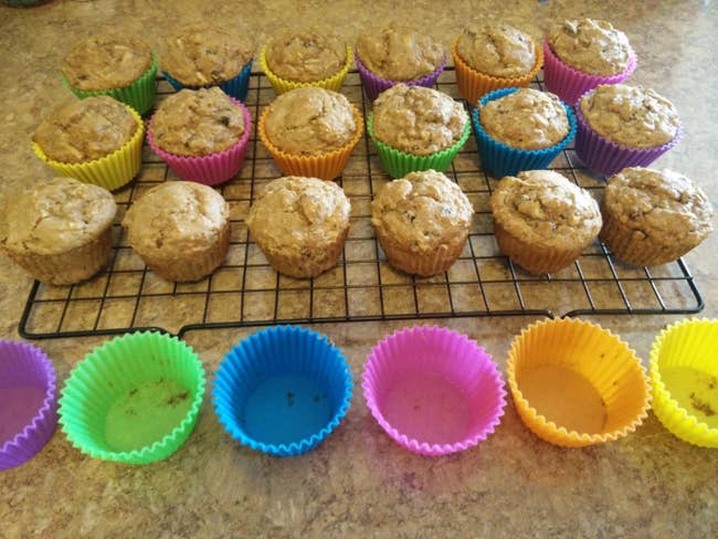 A reviewer showing muffins removed from the silicone cups
