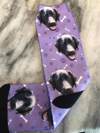 reviewer's purple socks with their dog on it