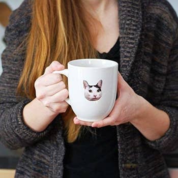 a sticker of a cat on a mug