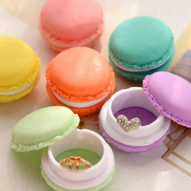 Several containers of different colors and they're shaped like macarons