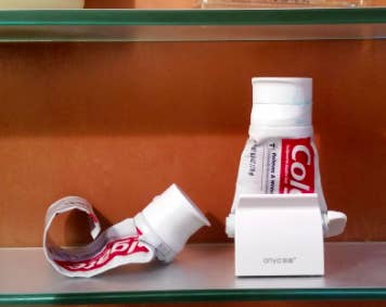tube of toothpaste in the stand/squeezer
