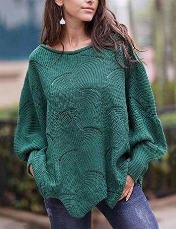 a model int he sweater in green