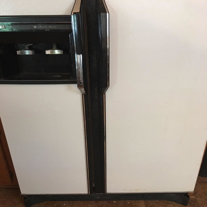 the same refrigerator now clean after being treated with the adhesive remover