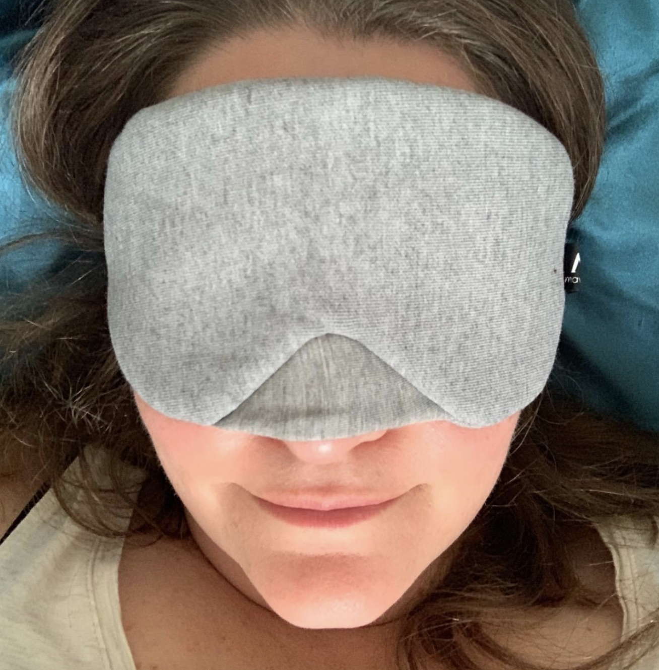 reviewer wearing the grey sleeping mask