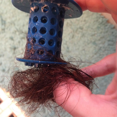 reviewer pulling hair from the drainer
