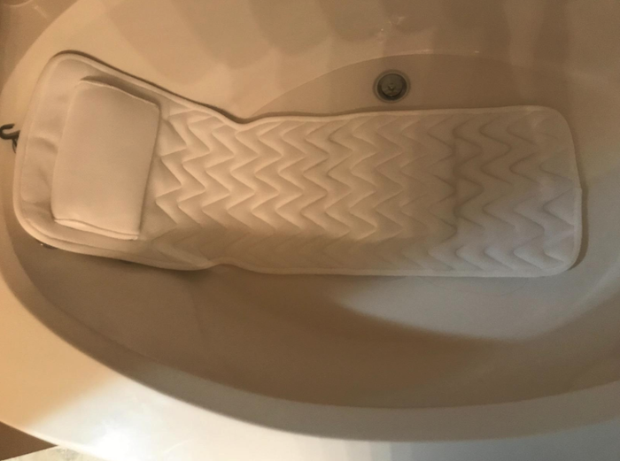 the bath pillow spread across the entire length of a jacuzzi tub