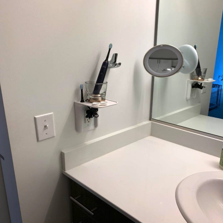 Power perch with a cup of toothbrushes on it