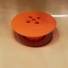 the tub drainer sitting in the drain. It has five holes for allowing water to pass through properly.