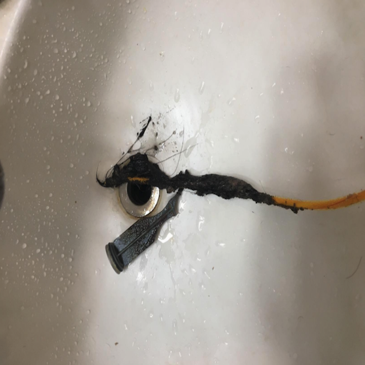 flexisnake being pulled out of the drain with loads of gunk from it