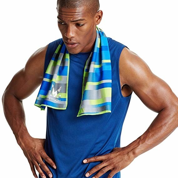 person in workout gear with towel around neck