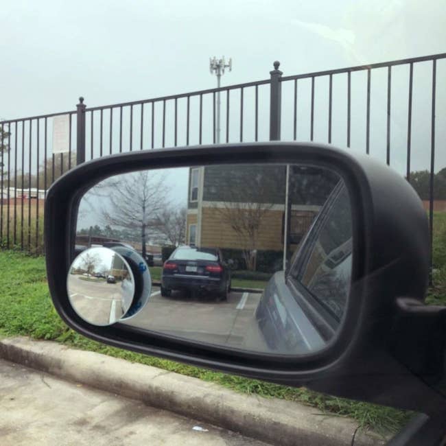 a circle blind spot mirror on the driver's side mirror