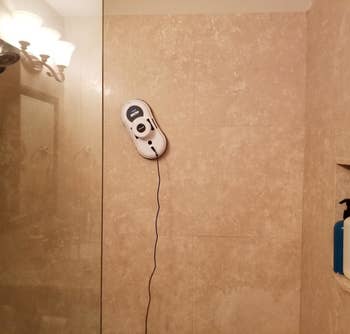 Reviewer's device cleaning a shower wall