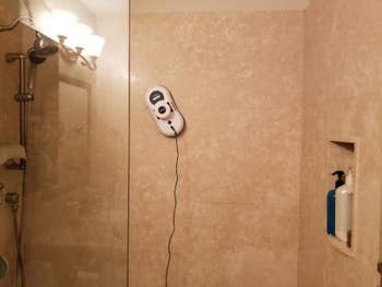 Reviewer image of the cleaner cleaning a shower wall