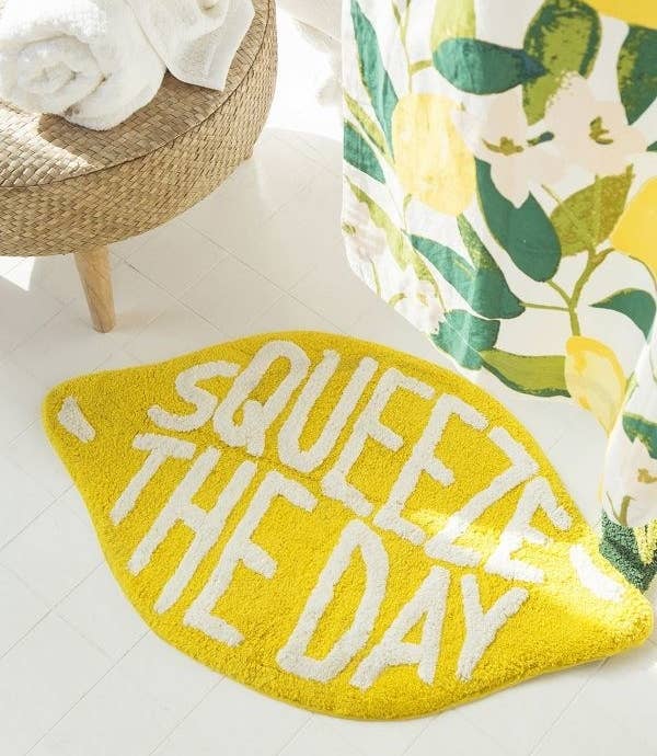 Lemon shaped bath mat that says Squeeze The Day 