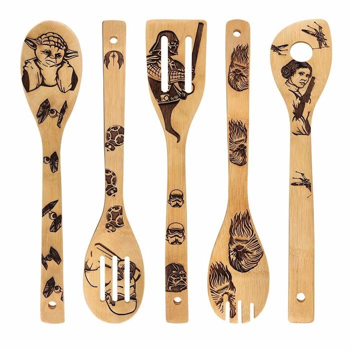 five wooden cooking utensils with star wars characters engraved in them (yes Yoda is there)