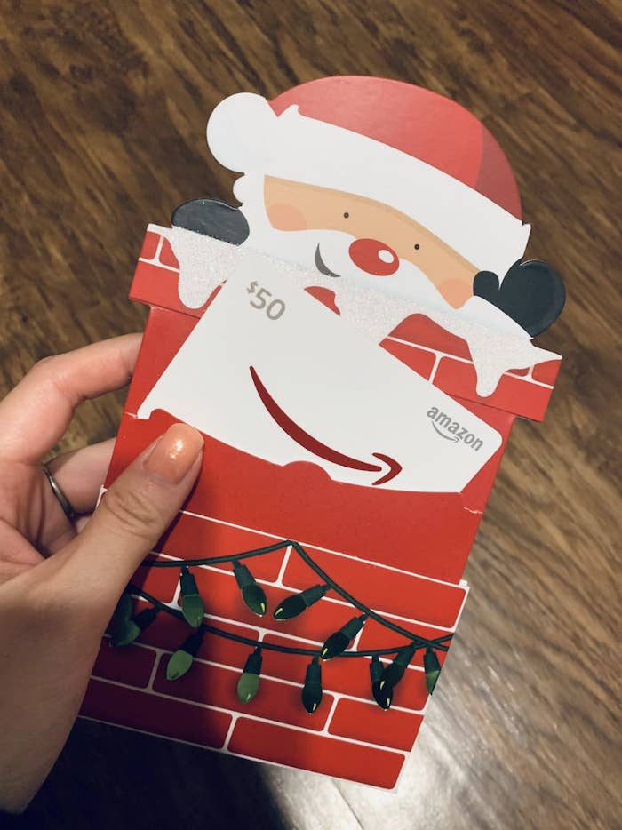 Reviewer photo of a gift card shaped like Santa Clause&#x27;s head popping out of a chimney