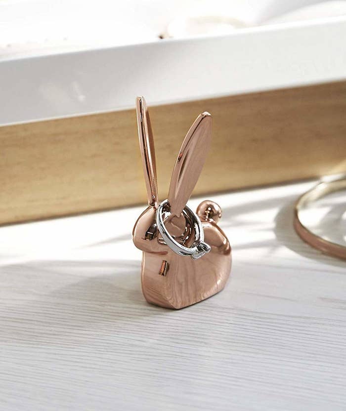 A rabbit-shaped metal ring holder on a table