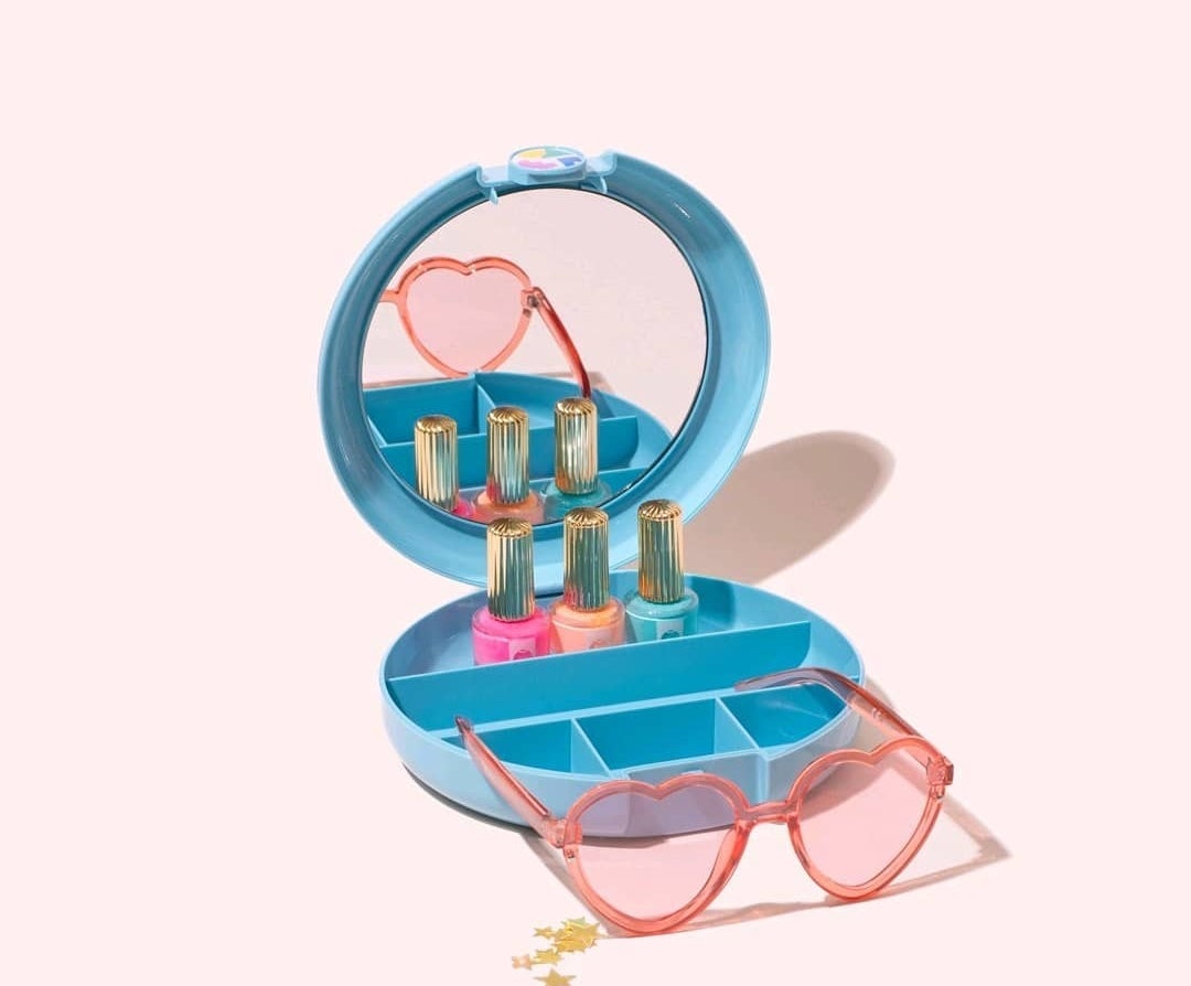 A small plastic makeup organizer that&#x27;s open with a mirror on the one side and small compartments on the lower half