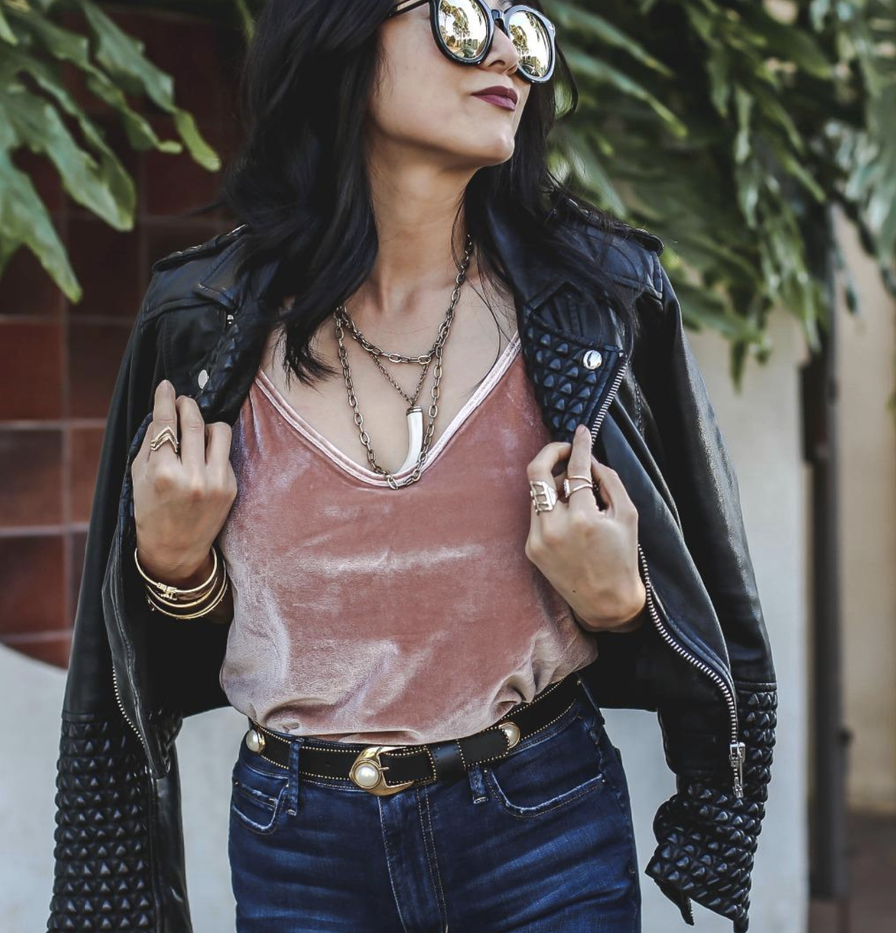 reviewer wearing the top in pink with a black leather jacket and jeans 