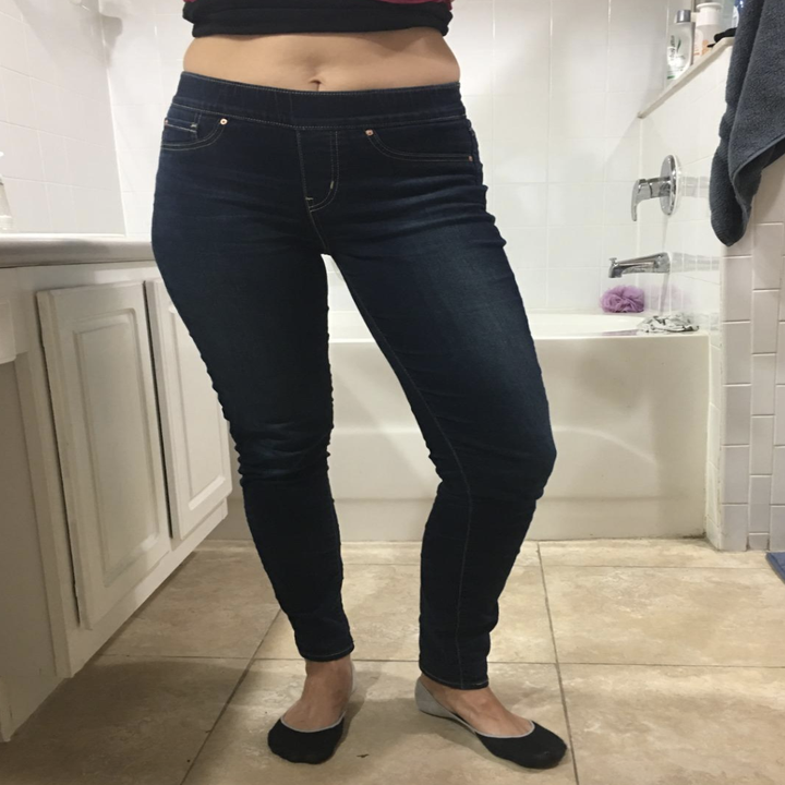 reviewer wearing the jeans in dark blue 
