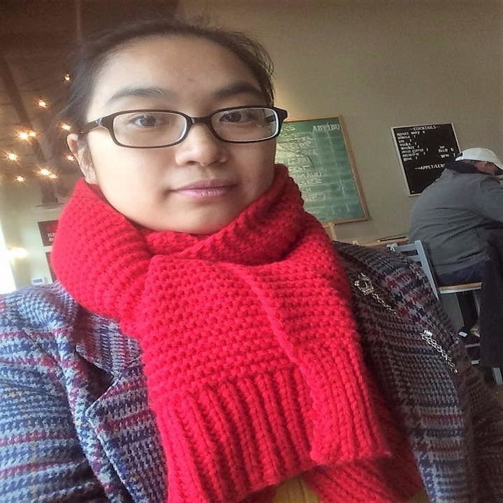 reviewer wearing the scarf in red 